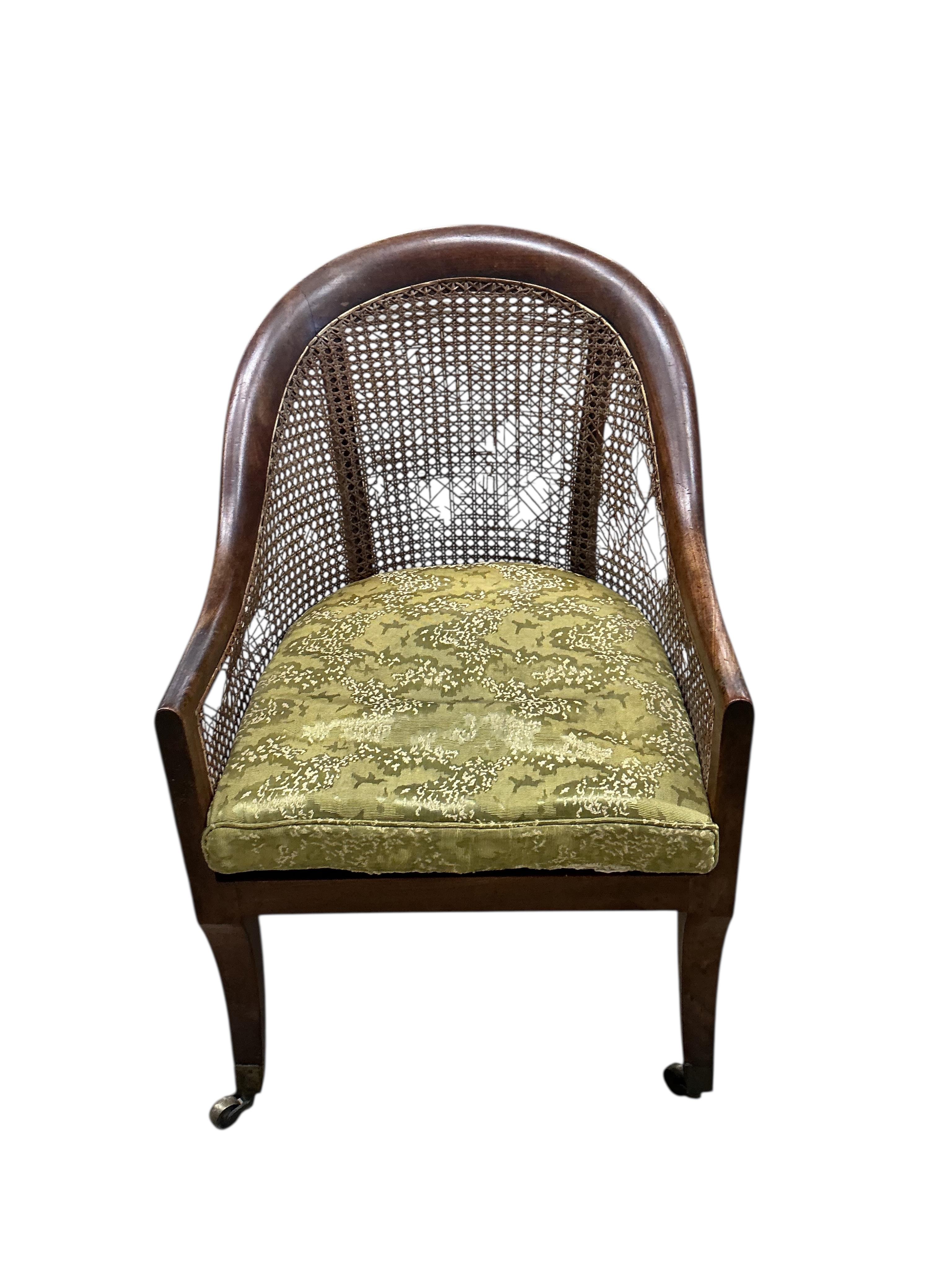 A Regency mahogany caned bergere armchair, (damaged cane) together with a Regency simulated rosewood and brass caned bergere armchair, larger width 49cm, depth 60cm, height 83cm